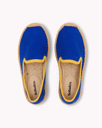 Overhead image of blue kids smoking slipper espadrille with yellow piping trim