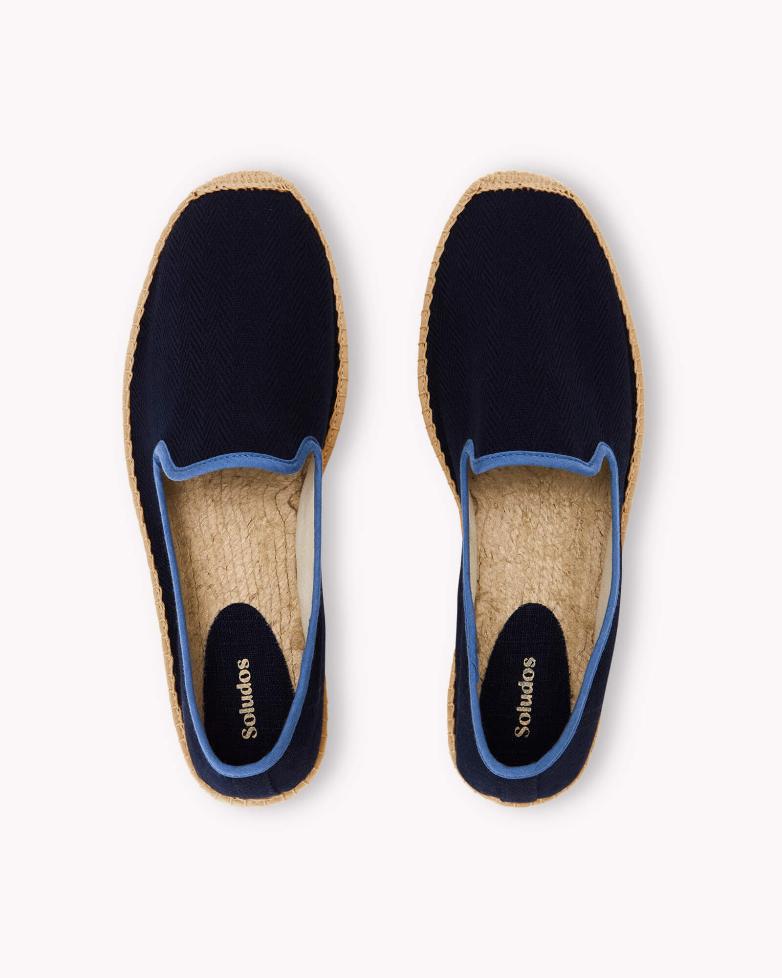 Men's navy espadrille shoes with blue piping on gray background