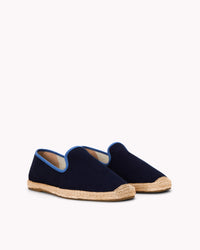 Men's navy espadrille shoes with blue piping on gray background