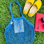 Blue mesh bag on grass